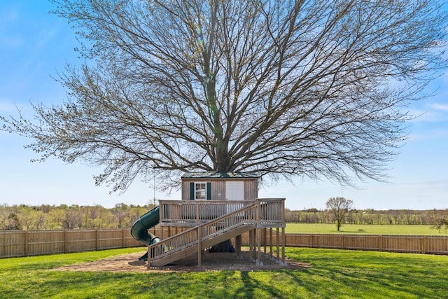 exterior space featuring a yard, stairway, a wooden deck, and a fenced backyard