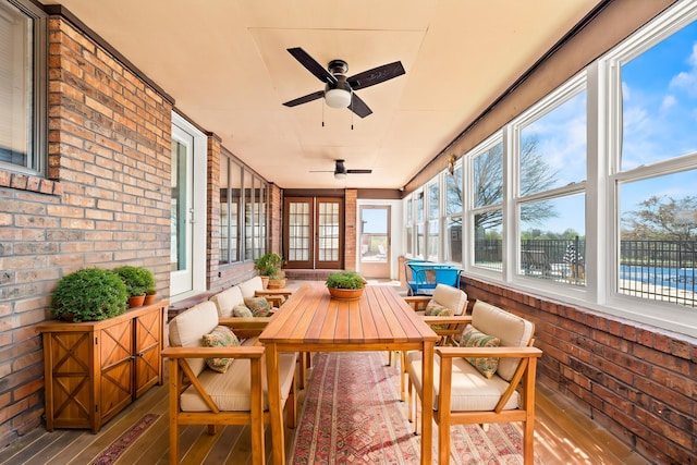 sunroom with an outdoor hangout area, french doors, and a ceiling fan