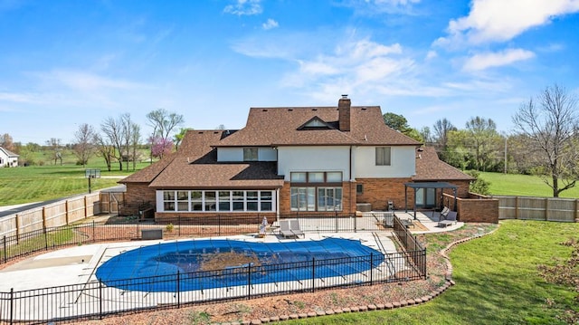 view of swimming pool with a lawn, a patio area, and a fenced backyard