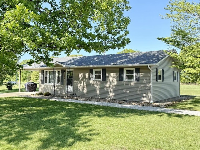 single story home featuring a front yard and an attached carport