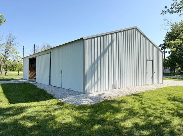 view of pole building with a yard