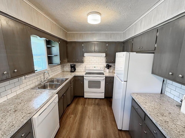 kitchen featuring a sink, ornamental molding, a textured ceiling, and white appliances