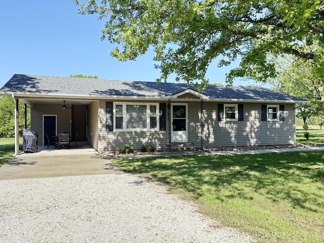 single story home featuring concrete driveway, a patio area, an attached carport, and a front lawn