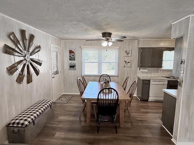 dining area with a textured ceiling, baseboards, a ceiling fan, and dark wood finished floors