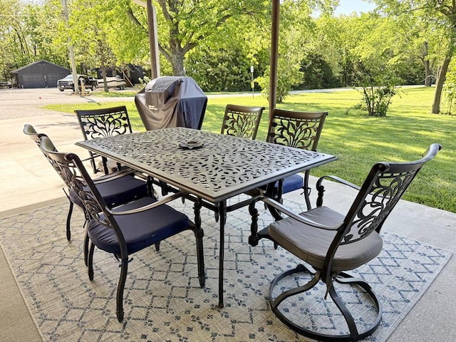 view of patio with area for grilling and outdoor dining space