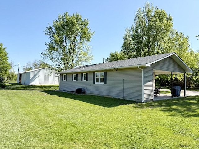 rear view of house with a lawn, a patio, central AC, and crawl space