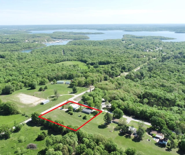 aerial view with a water view and a forest view