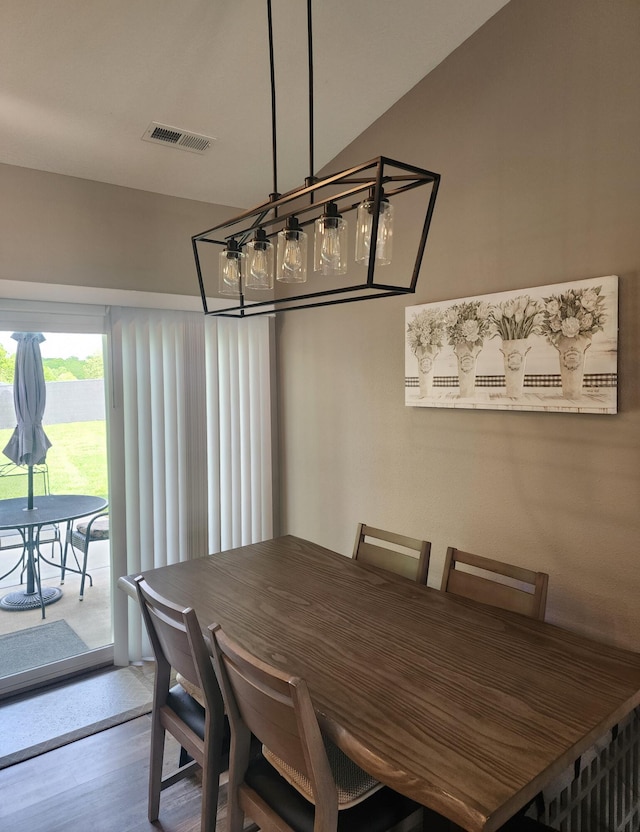 dining room featuring visible vents and wood finished floors