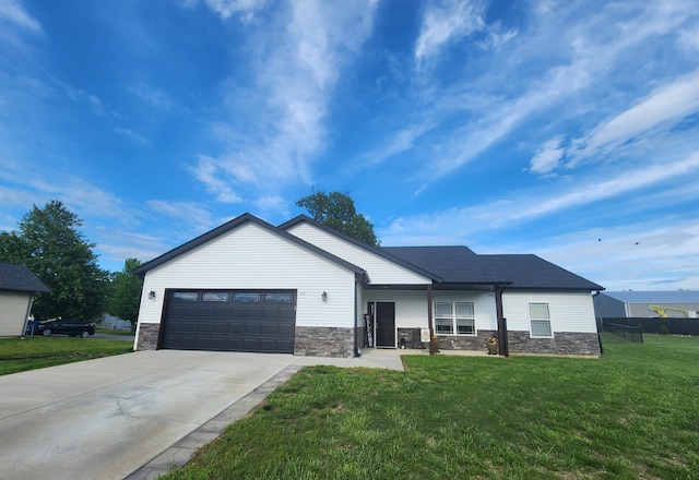 single story home with a front lawn, driveway, an attached garage, and stone siding