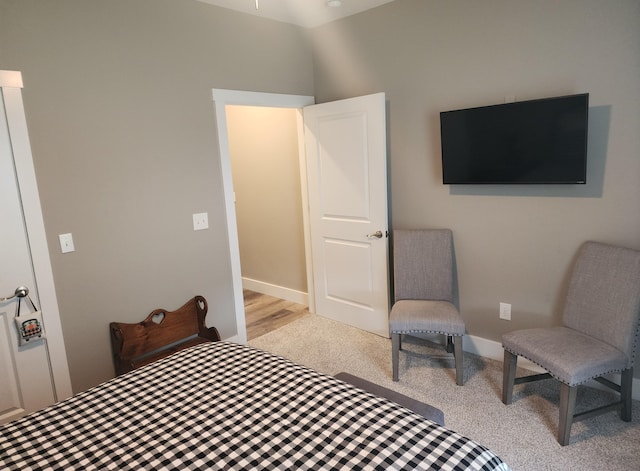 bedroom featuring carpet and baseboards