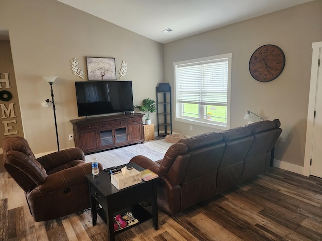 living area with wood finished floors and baseboards