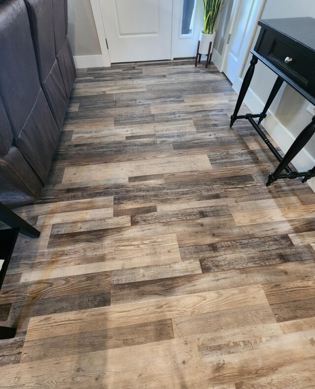 room details with baseboards and wood finished floors