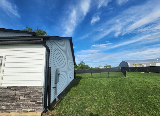 view of home's exterior featuring a yard and fence