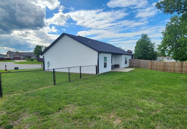 rear view of property with a patio area, a gate, a lawn, and a fenced backyard