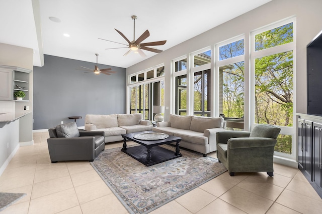 living room with light tile patterned floors, baseboards, and ceiling fan