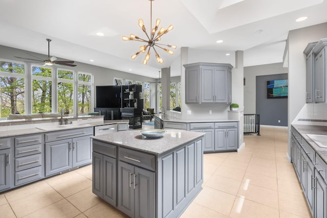 kitchen with recessed lighting, gray cabinetry, ceiling fan with notable chandelier, and a sink