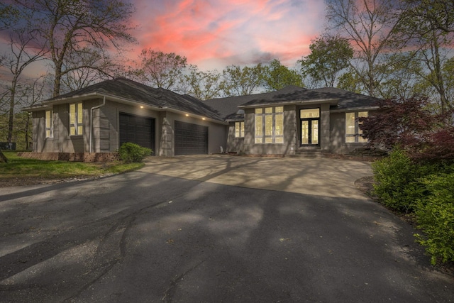 prairie-style home featuring a garage and driveway