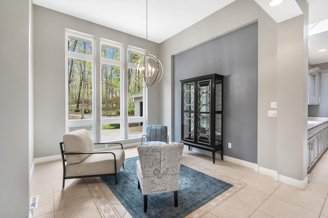 sitting room featuring baseboards, a notable chandelier, and light tile patterned floors