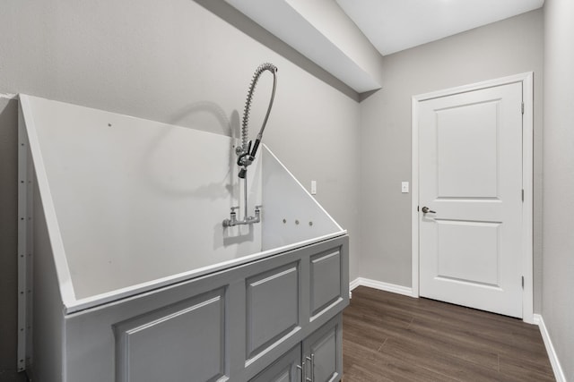 room details featuring baseboards and wood finished floors