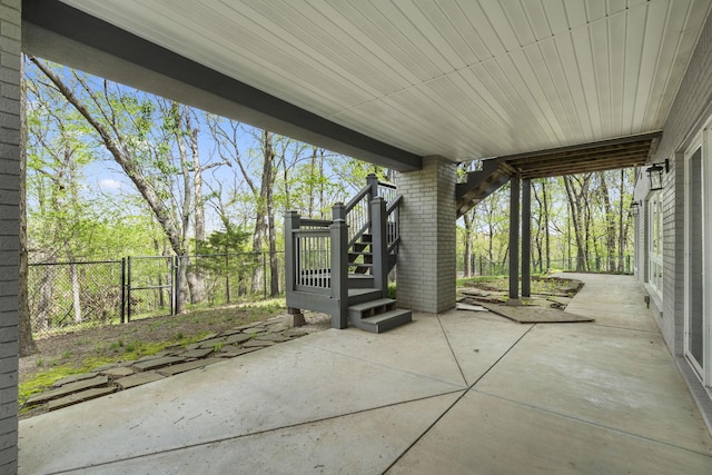 view of patio / terrace with stairway and fence