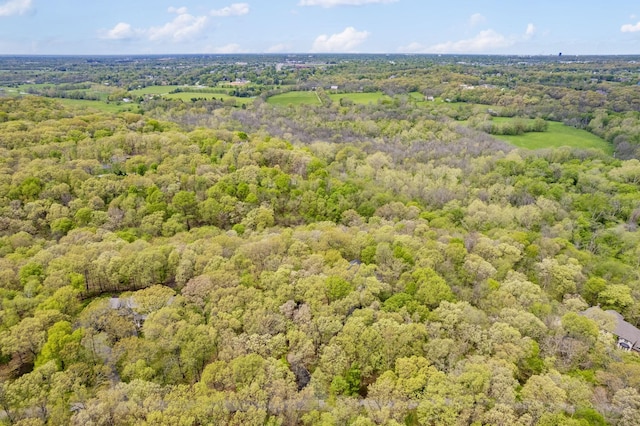 drone / aerial view featuring a wooded view