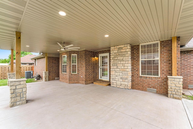 view of patio / terrace with cooling unit, fence, entry steps, and ceiling fan