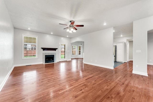 unfurnished living room with a ceiling fan, light wood-style floors, recessed lighting, and plenty of natural light