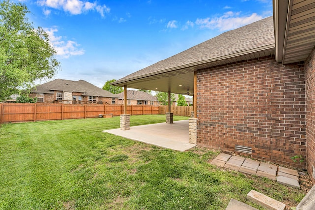 view of yard featuring a fenced backyard, a patio, and a ceiling fan