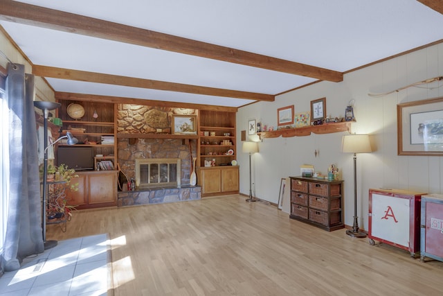 2941 S Versailles Ave, Springfield, MO 65804 - unfurnished living room featuring a stone fireplace, wood finished floors, and beamed ceiling