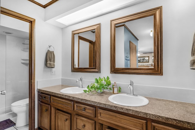 2941 S Versailles Ave, Springfield, MO 65804 - bathroom featuring walk in shower, double vanity, toilet, and a sink