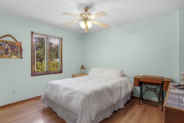 2941 S Versailles Ave, Springfield, MO 65804 - bedroom featuring baseboards, light wood finished floors, and a ceiling fan