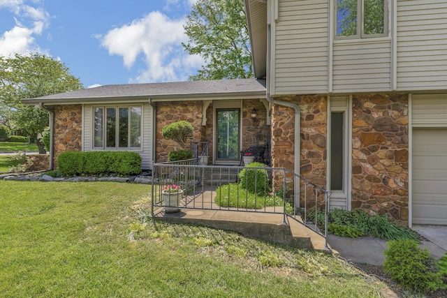 2941 S Versailles Ave, Springfield, MO 65804 - property entrance with stone siding, a shingled roof, a yard, and a garage