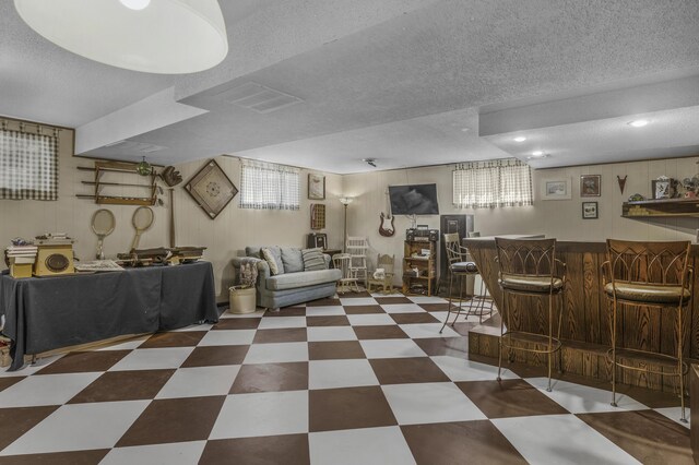 2941 S Versailles Ave, Springfield, MO 65804 - living room with a textured ceiling, a dry bar, and tile patterned floors