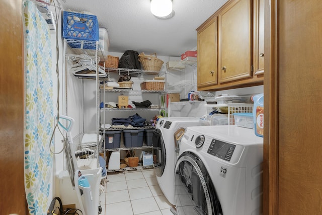 2941 S Versailles Ave, Springfield, MO 65804 - laundry area featuring washing machine and clothes dryer, light tile patterned floors, and cabinet space