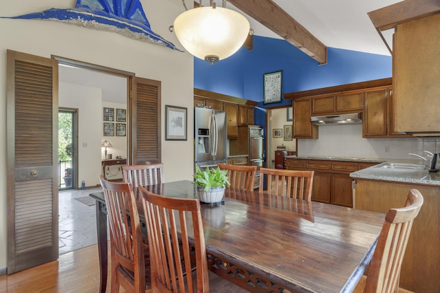 2941 S Versailles Ave, Springfield, MO 65804 - dining space featuring light wood-type flooring, high vaulted ceiling, and beam ceiling