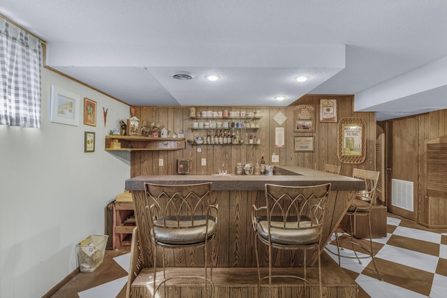 2941 S Versailles Ave, Springfield, MO 65804 - bar with wooden walls, baseboards, indoor wet bar, and visible vents