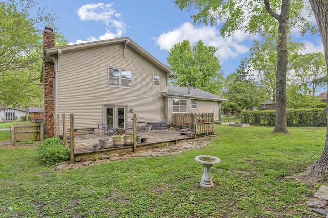 2941 S Versailles Ave, Springfield, MO 65804 - back of house with a lawn, fence, a chimney, and a wooden deck