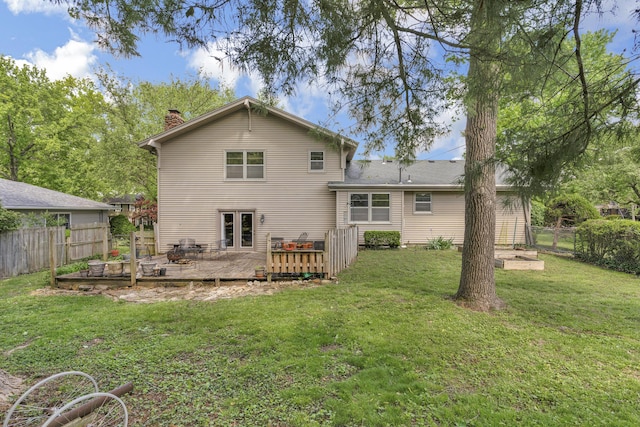 2941 S Versailles Ave, Springfield, MO 65804 - rear view of house featuring a chimney, a yard, a deck, and fence private yard