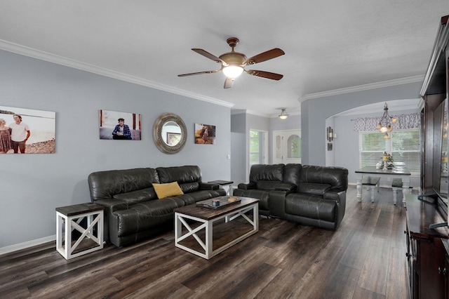 living area with a ceiling fan, dark wood finished floors, baseboards, arched walkways, and ornamental molding