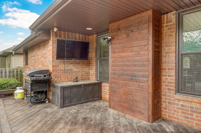 view of patio featuring a grill and fence