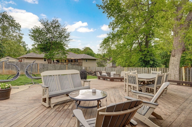 deck with a fenced backyard and outdoor dining space
