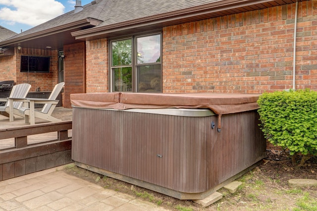 exterior space with a hot tub