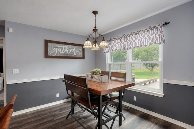 dining space featuring baseboards, a notable chandelier, visible vents, and dark wood-style floors