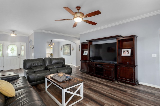 living room featuring dark wood-type flooring, ceiling fan with notable chandelier, and arched walkways