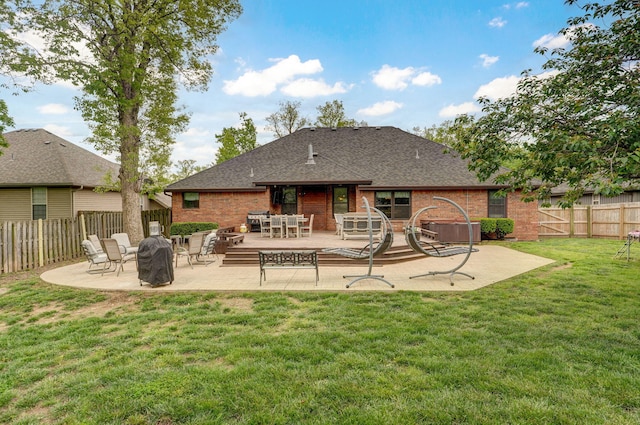 rear view of house featuring a lawn, a patio area, a fire pit, and a fenced backyard