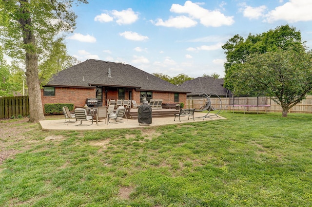 back of house with a patio area, a lawn, and a fenced backyard