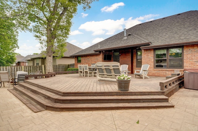 wooden terrace with outdoor dining area and fence
