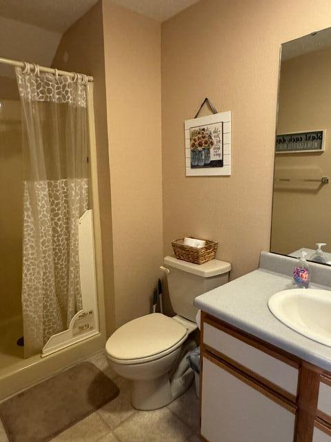 17 Fall Creek Trl Unit 7, Branson, MO 65616 - bathroom featuring toilet, tile patterned flooring, vanity, and a stall shower