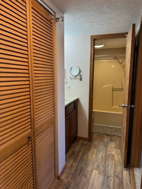 17 Fall Creek Trl Unit 7, Branson, MO 65616 - bathroom with a closet, a textured ceiling, shower / tub combination, vanity, and wood finished floors