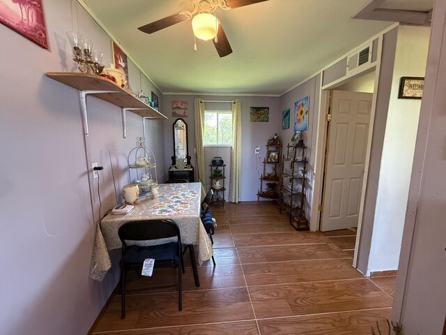 dining space featuring ceiling fan, ornamental molding, visible vents, and wood finished floors